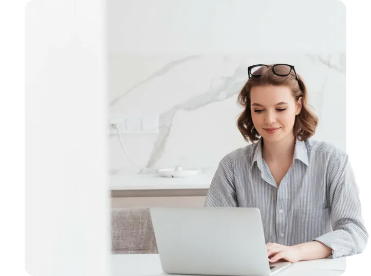 Woman working at a desk using a laptop