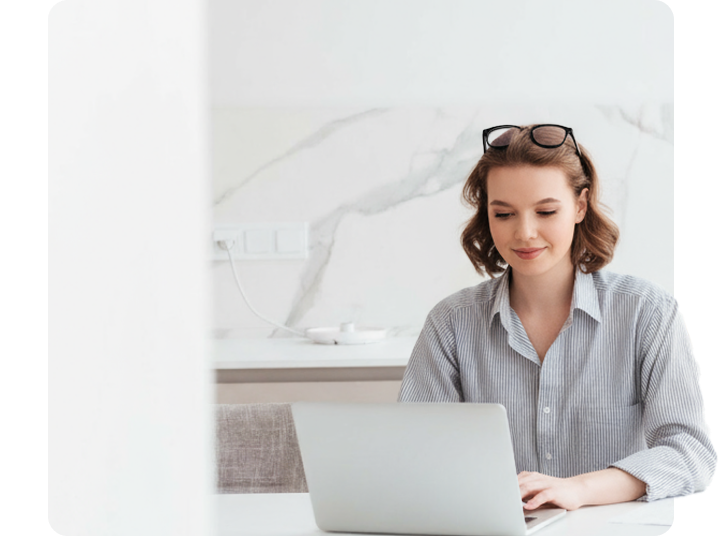 Woman working at a desk using a laptop